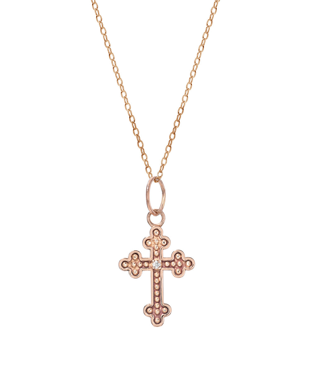 The 14KT Gold Diamond Cross Fleury Pendant Necklace (0.005 CT.) features an ornate gold cross with beaded detailing, displayed on a simple white background—an elegant accessory for any occasion.
