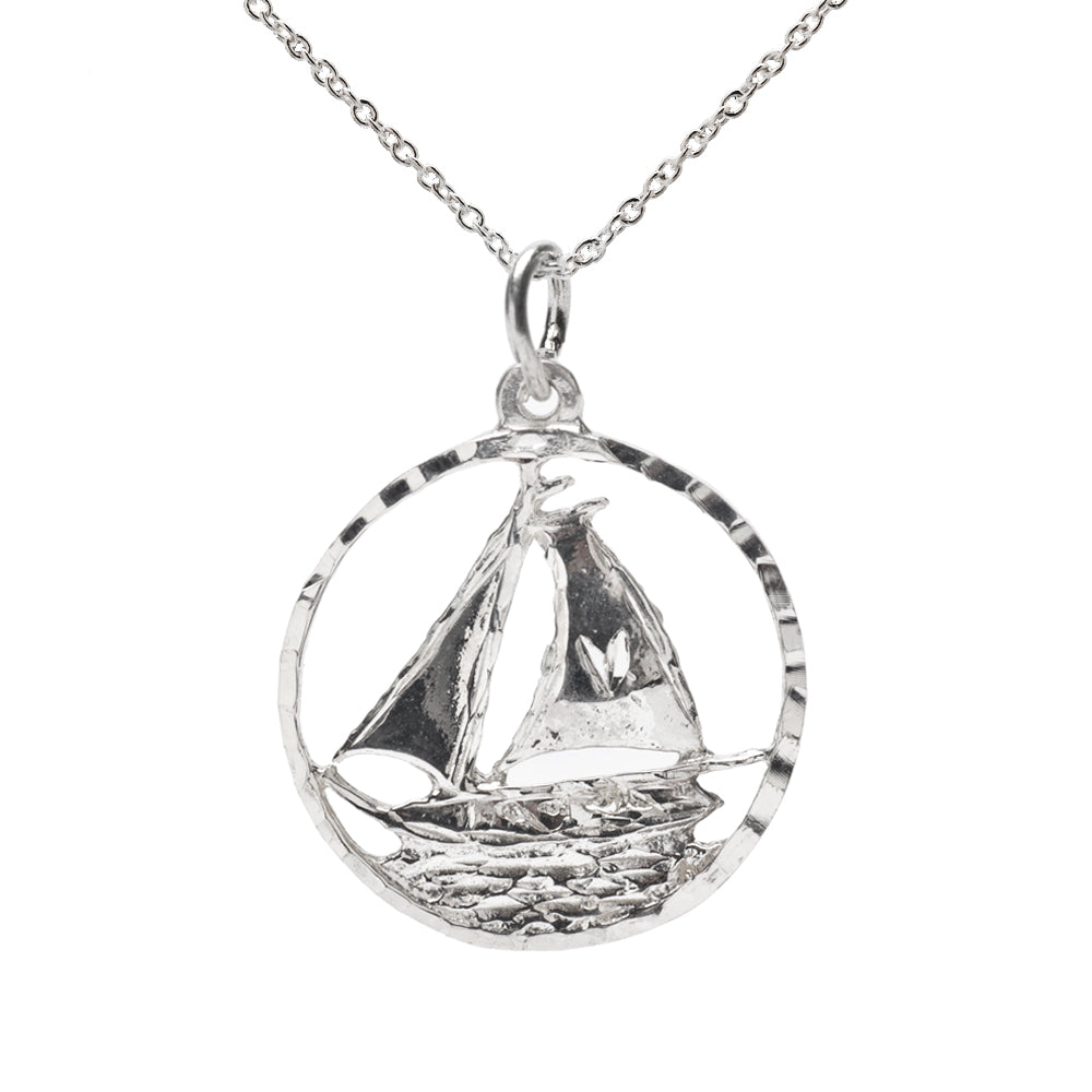 The Sterling Silver Round Sailboat Sailing Pendant Necklace showcases a detailed sailboat inside an open circular pendant—an ideal choice for nautical jewelry lovers.