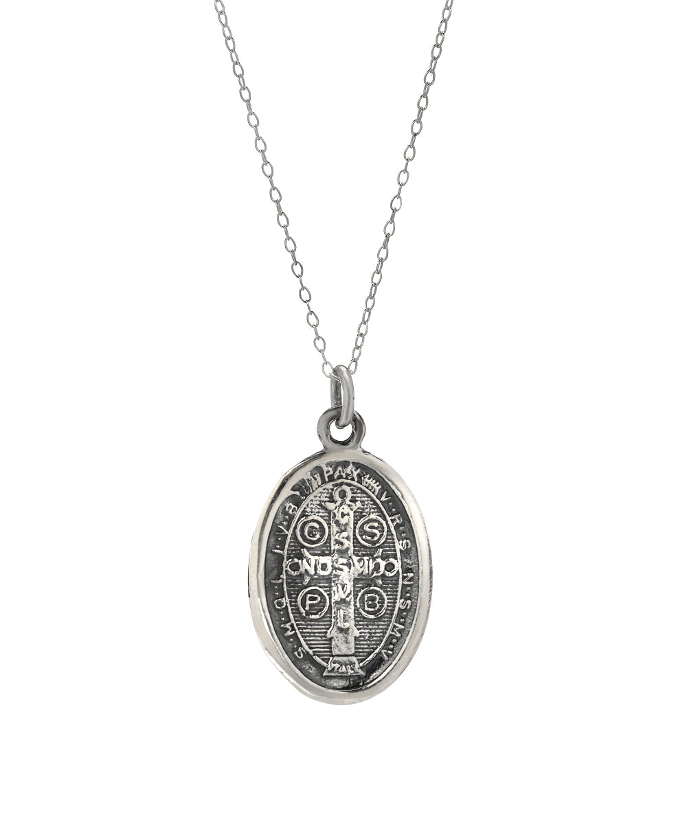 The Sterling Silver Saint Benedict Protect Us Pendant Necklace, 18", features religious symbols and inscriptions on a pendant hanging from a delicate chain, shown against a white background.