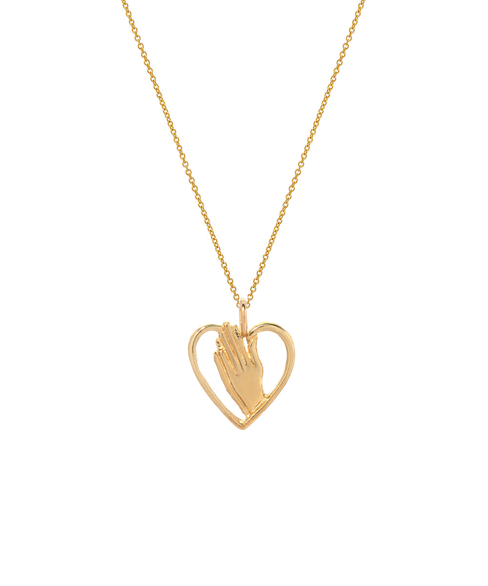 The 14 Karat Yellow Gold Praying Hands in Heart Pendant Necklace features two hands in prayer inside a heart, offering an elegant, minimalistic design that makes this piece timeless.