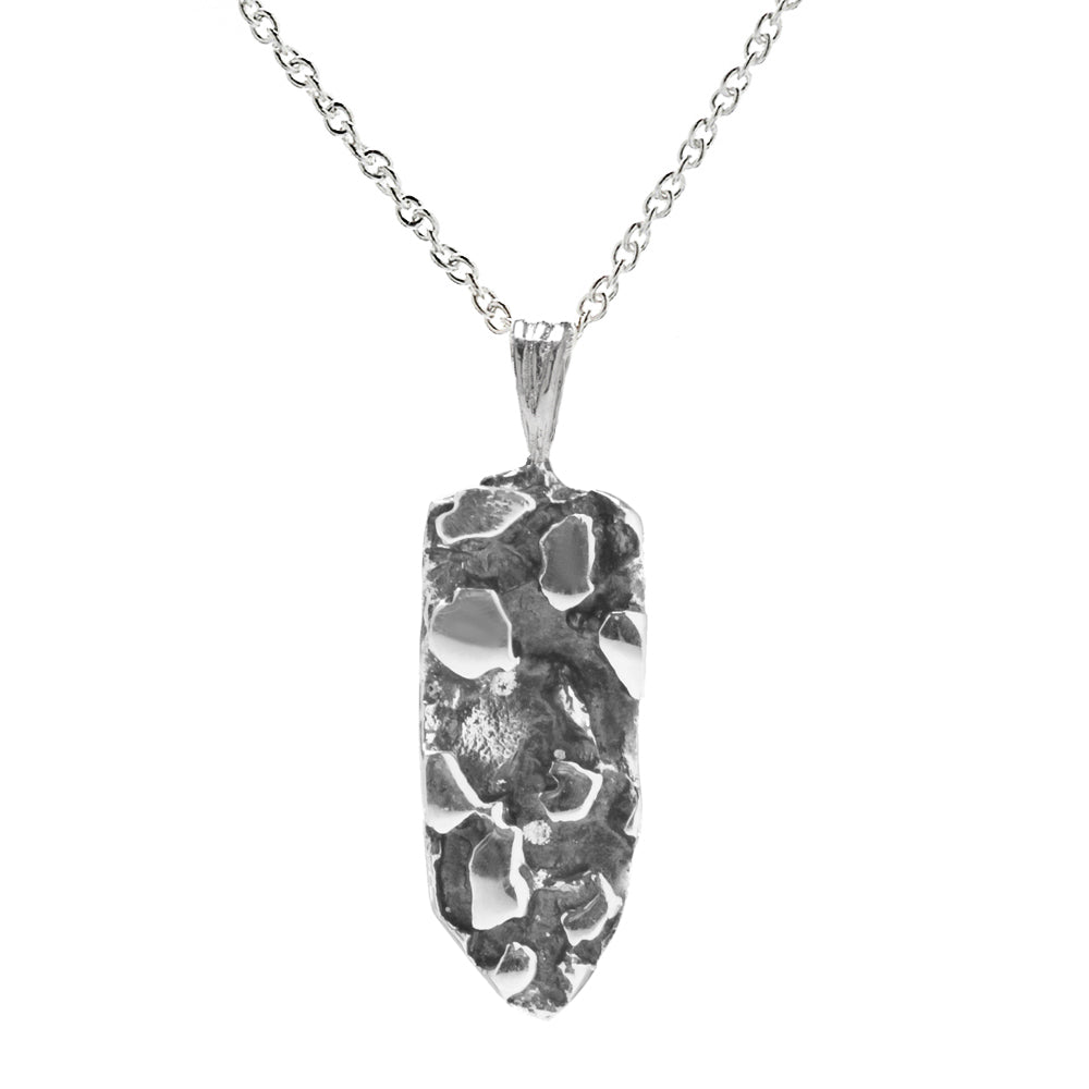 The Sterling Silver Nugget Pendant Necklace features a uniquely textured, irregular nugget charm with polished and rough surfaces—ideal for lovers of nature-inspired jewelry.