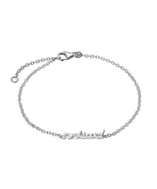 The Sterling Silver Chain Wrist and Ankle Name Bracelet is a delicate 925 sterling silver piece with a lobster clasp, featuring a center charm that spells "sunkissed" in cursive letters.