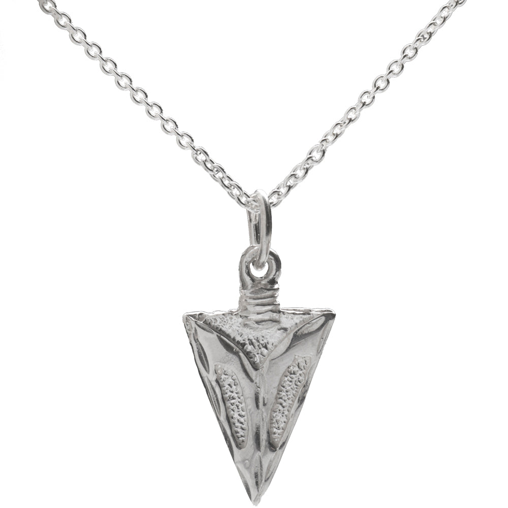 The Sterling Silver Arrowhead Pendant Necklace features intricate patterns on a thin chain, making it a stylish unisex accessory for men and women.
