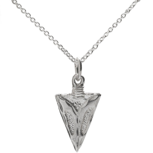 The Sterling Silver Arrowhead Pendant Necklace features intricate patterns on a thin chain, making it a stylish unisex accessory for men and women.