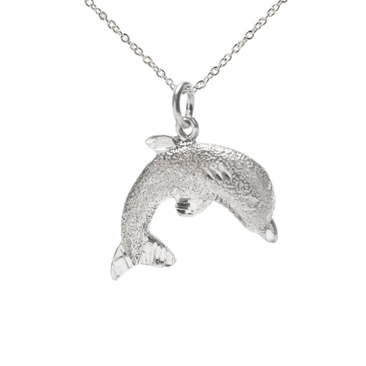 The Sterling Silver Jumping Dolphin Pendant Necklace showcases a textured, jumping dolphin on a sleek chain, set against a plain white background for an elegant ocean-inspired look.