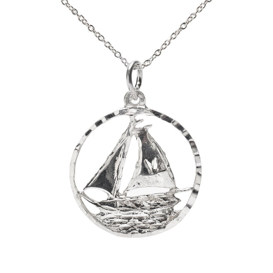 The Sterling Silver Round Sailboat Sailing Pendant Necklace showcases a detailed sailboat inside an open circular pendant—an ideal choice for nautical jewelry lovers.