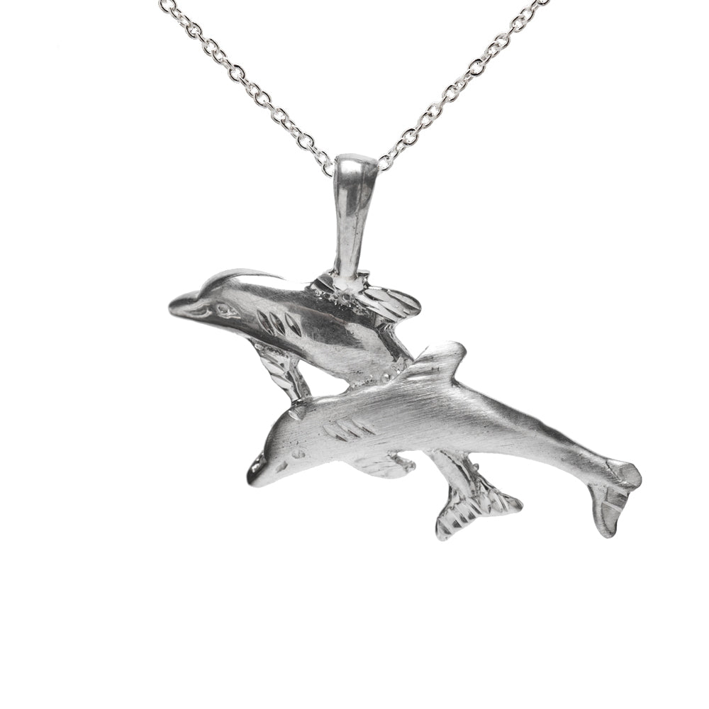 The Sterling Silver Jumping Dolphins Pendant Necklace features two detailed dolphins leaping side by side on a delicate chain, making it the perfect gift for ocean lovers.