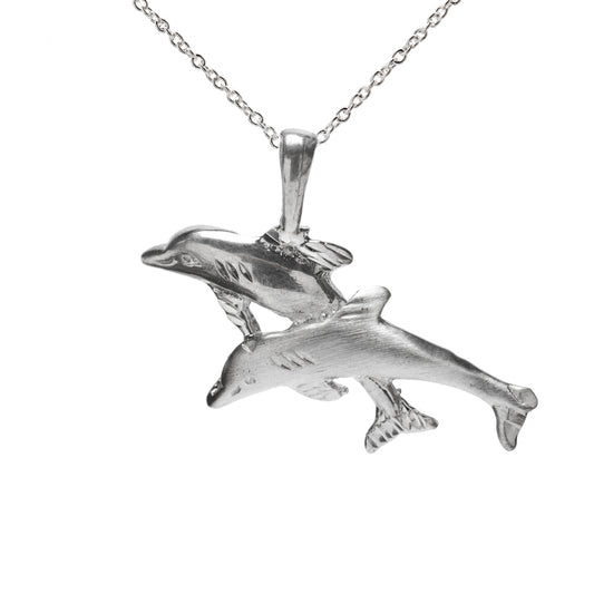 The Sterling Silver Jumping Dolphins Pendant Necklace features two detailed dolphins leaping side by side on a delicate chain, making it the perfect gift for ocean lovers.