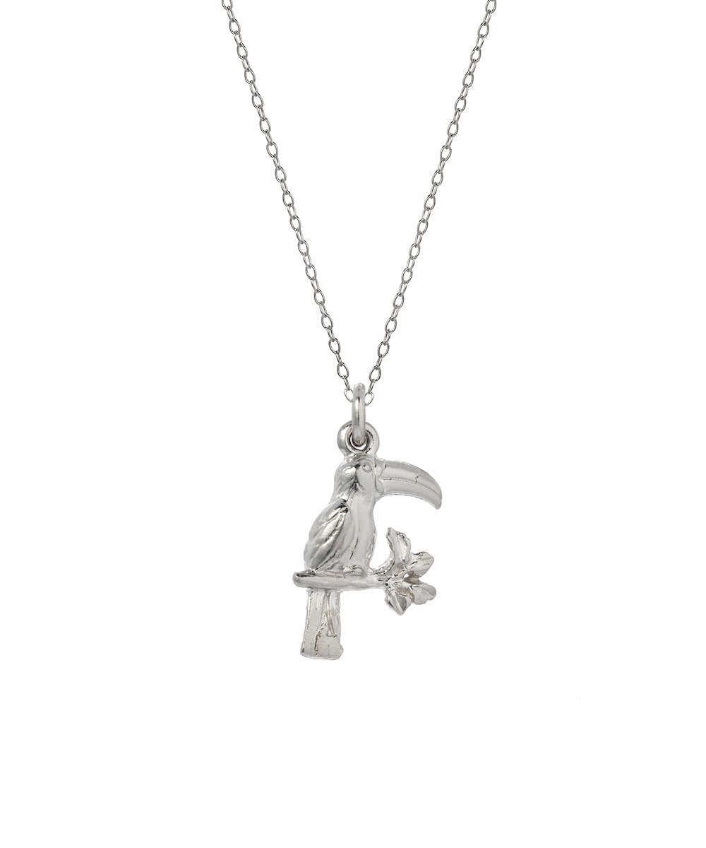 The Sterling Silver Toucan Bird Pendant Necklace features a 925 silver toucan perched on a branch with a flower, shown against a plain white background.
