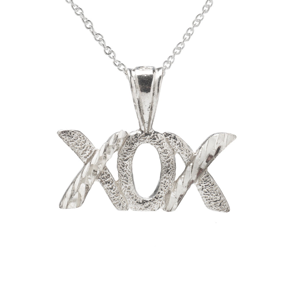 The Sterling Silver XOX Pendant Necklace features a polished, reflective "hugs and kisses" pendant on a simple 925 sterling silver chain, adding textured shine and charm to any look.