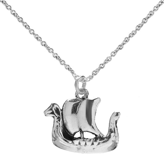 The Sterling Silver Viking Ship Pendant Necklace, shaped like a longship with a curved hull, dragon head prow, and single sail, hangs from a delicate chain and is displayed elegantly against a white background.