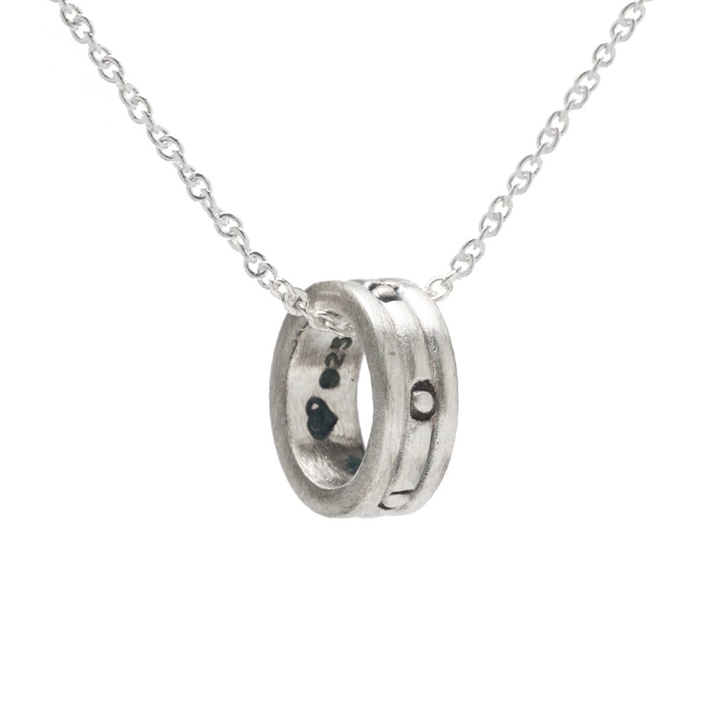 The Sterling Silver Eternity Rondel Pendant Necklace, 18", features a round, textured ring with dark accents—ideal for fans of minimalist jewelry.
