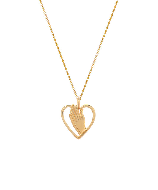 The 14 Karat Yellow Gold Praying Hands in Heart Pendant Necklace features two hands in prayer inside a heart, offering an elegant, minimalistic design that makes this piece timeless.
