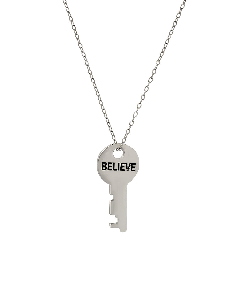 The Sterling Silver Infinite Key Pendant Necklace features the word BELIEVE engraved in bold black letters and hangs from a delicate chain, shown against a plain white background as an elegant affirmation accessory.