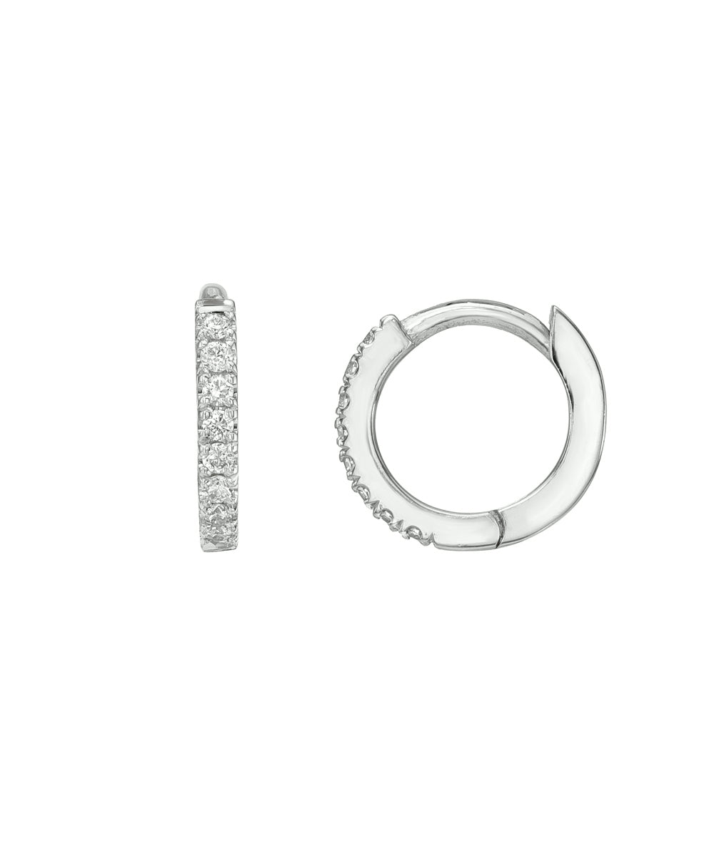 A pair of 14 Karat Yellow Gold Diamond Pave Huggie Hoops are shown on a white background; one earring reveals a row of sparkling diamonds, while the other highlights the hoop’s sleek side profile.